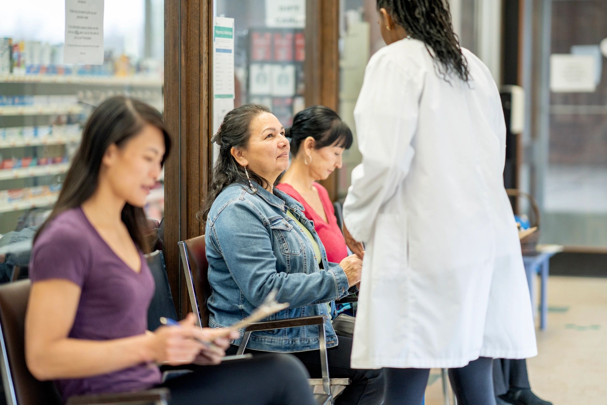 Healthcare professional speaking with patients in a clinic